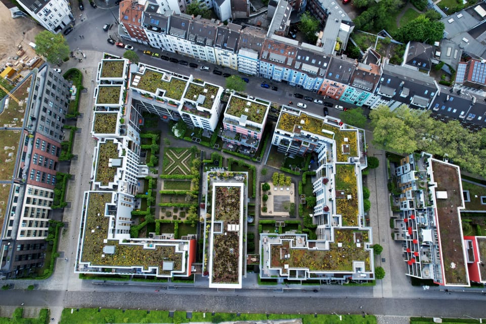Aerial view of green-roofed buildings and courtyards in a sustainable urban district in Düsseldorf, Germany. Source: Envato Elements.
